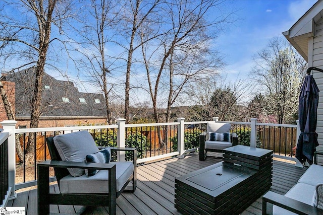 wooden terrace with an outdoor hangout area