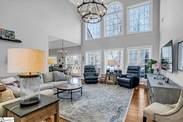 living room with wood finished floors and a chandelier