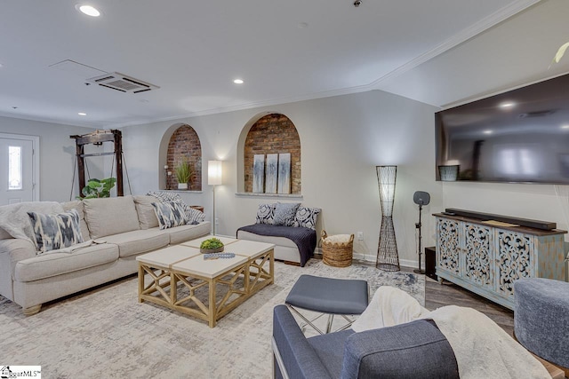 living room featuring visible vents, baseboards, vaulted ceiling, ornamental molding, and recessed lighting