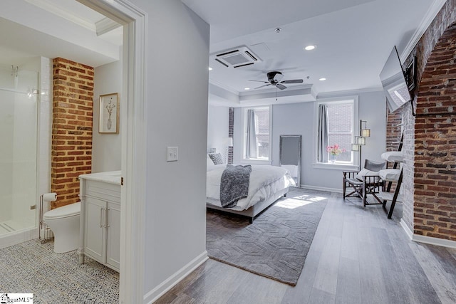 bedroom with baseboards, light wood-style floors, and crown molding