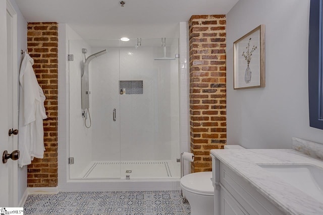 full bathroom with vanity, brick wall, a stall shower, tile patterned flooring, and toilet