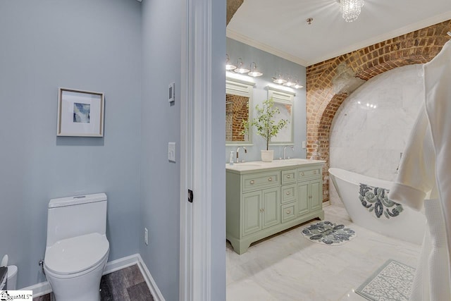 full bath featuring double vanity, a soaking tub, toilet, and a sink