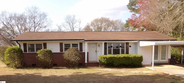 single story home with a shingled roof, a carport, brick siding, and crawl space