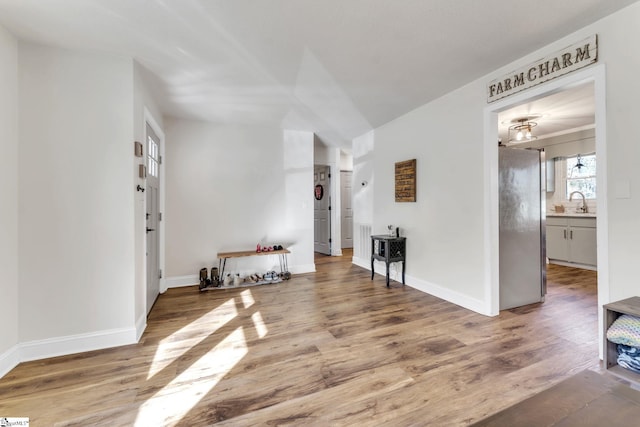 living area with wood finished floors and baseboards