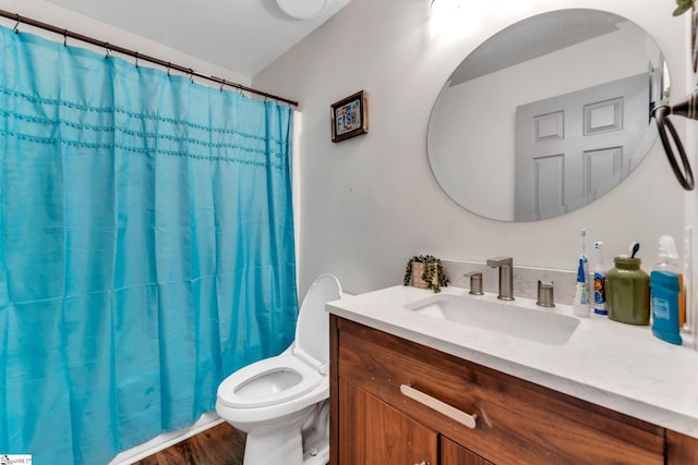 bathroom featuring toilet, vanity, a shower with curtain, and wood finished floors