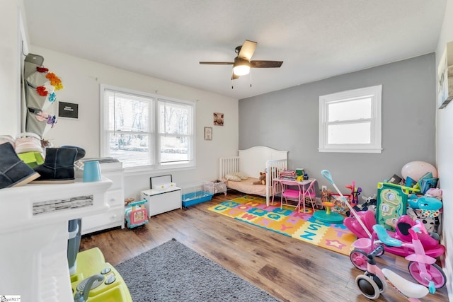 playroom featuring ceiling fan and wood finished floors