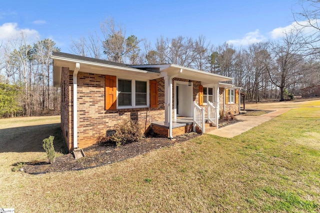 ranch-style home with a front yard, brick siding, and crawl space