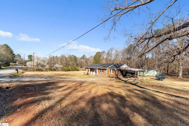 view of front of house with a carport, a porch, and a front lawn