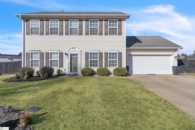 colonial inspired home with a garage, concrete driveway, a front lawn, and fence