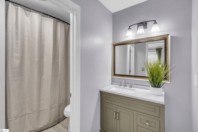 bathroom featuring a shower with curtain, toilet, and vanity