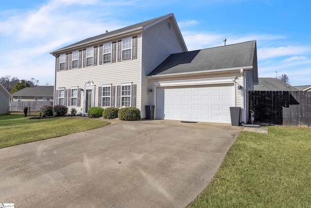 colonial inspired home with a garage, concrete driveway, a front lawn, and fence