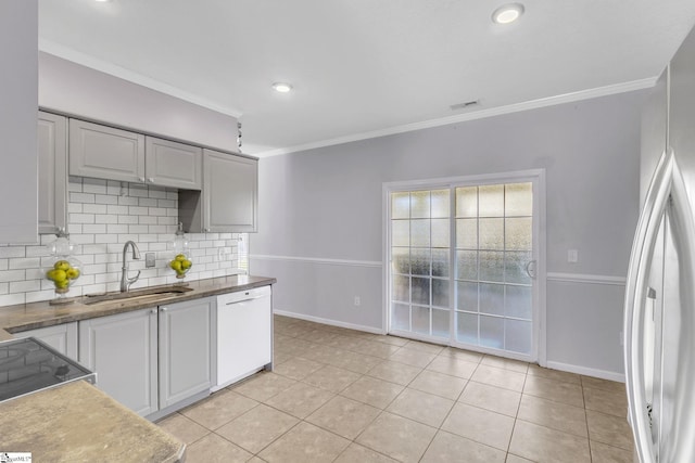 kitchen featuring tasteful backsplash, visible vents, ornamental molding, white dishwasher, and a sink