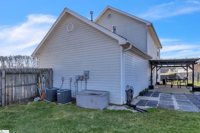 view of home's exterior featuring a yard, a patio area, cooling unit, and fence