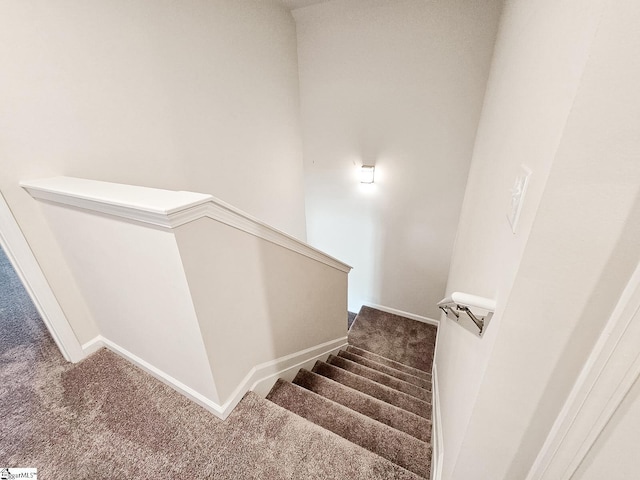 stairway featuring carpet flooring and baseboards