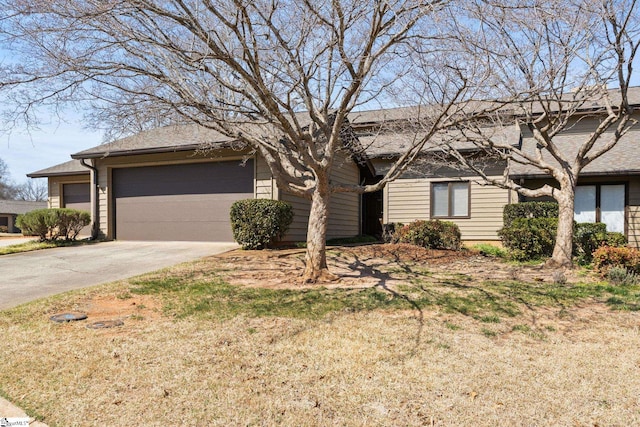 ranch-style house with a garage and concrete driveway