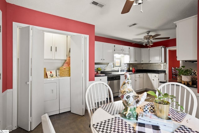 kitchen featuring stainless steel dishwasher, ceiling fan, visible vents, and washer and clothes dryer