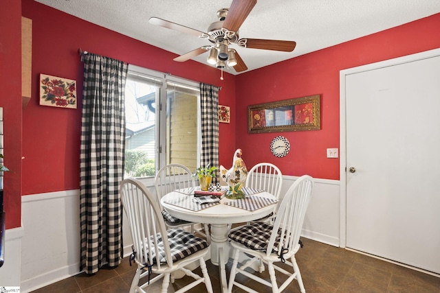 dining area featuring a textured ceiling and a ceiling fan