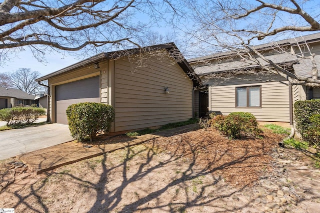 view of front of house featuring an outbuilding, concrete driveway, and a garage