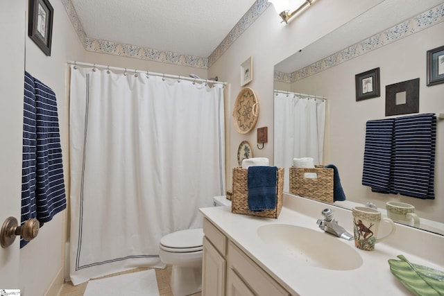 bathroom with a shower with curtain, a textured ceiling, vanity, and toilet