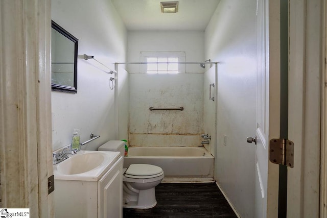 full bath with visible vents, toilet, shower / bathing tub combination, wood finished floors, and vanity