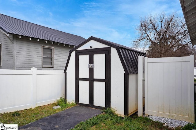 view of shed featuring fence