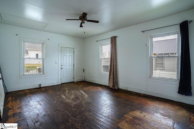 interior space with a healthy amount of sunlight, attic access, a ceiling fan, and hardwood / wood-style floors