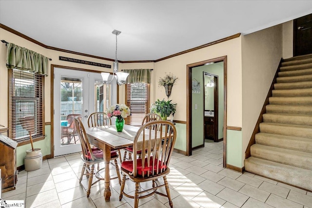 dining room featuring a chandelier, stairway, light tile patterned flooring, and ornamental molding