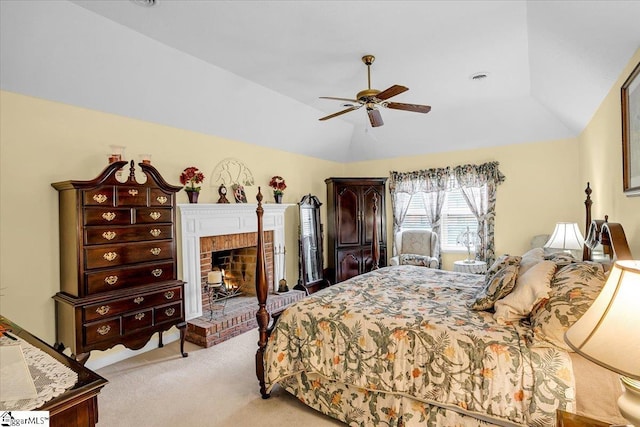 bedroom with a ceiling fan, visible vents, lofted ceiling, a brick fireplace, and light colored carpet