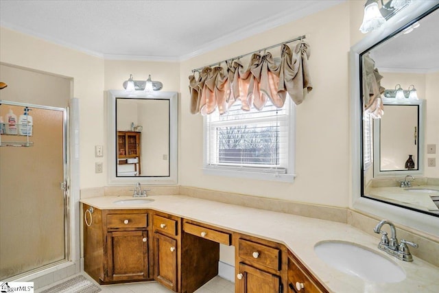 bathroom featuring a sink, a shower stall, and crown molding