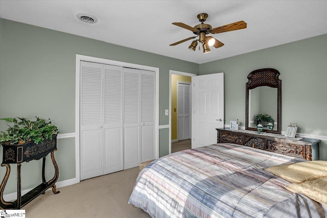 bedroom with visible vents, ceiling fan, baseboards, carpet floors, and a closet