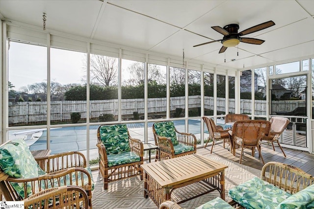 sunroom featuring a ceiling fan