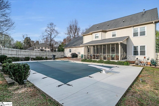 view of swimming pool with a patio, a fenced backyard, a fenced in pool, and a sunroom