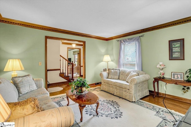 living area featuring stairs, wood finished floors, and baseboards