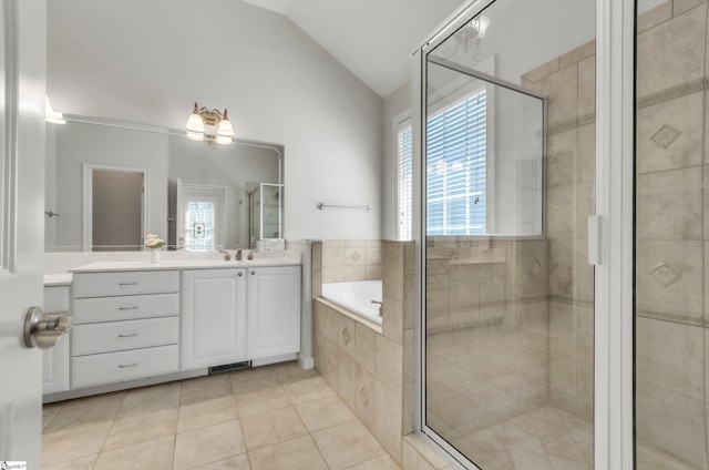 bathroom featuring vaulted ceiling, tile patterned floors, a garden tub, and a wealth of natural light