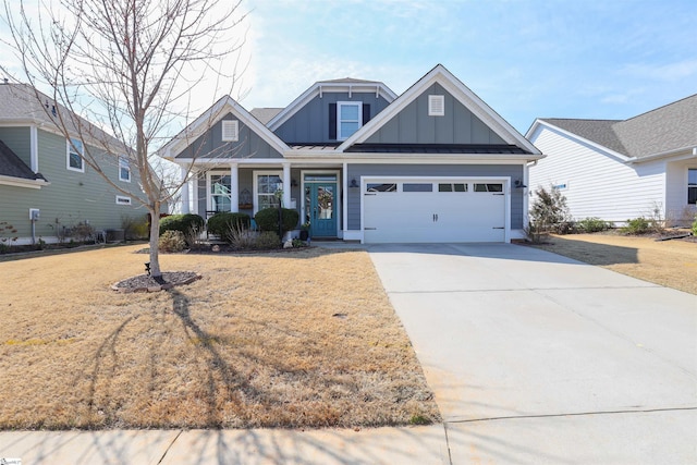 craftsman-style home featuring board and batten siding, concrete driveway, and a front yard