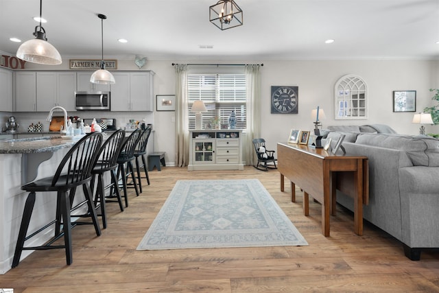 interior space featuring recessed lighting, light wood-type flooring, and ornamental molding