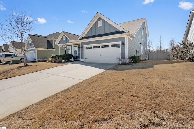 view of front facade featuring a standing seam roof, an attached garage, concrete driveway, a front lawn, and board and batten siding