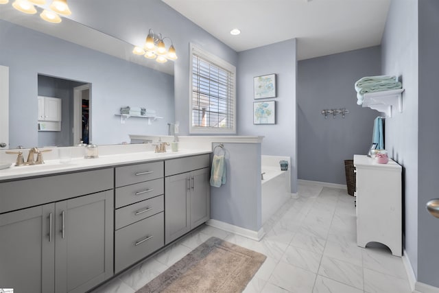 full bathroom featuring double vanity, marble finish floor, baseboards, and a sink