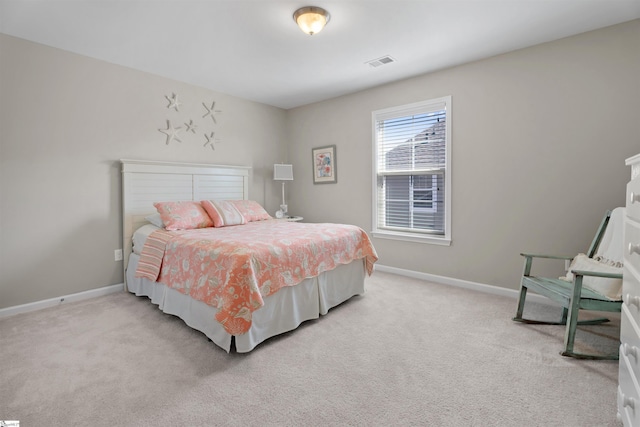 bedroom featuring visible vents, light carpet, and baseboards