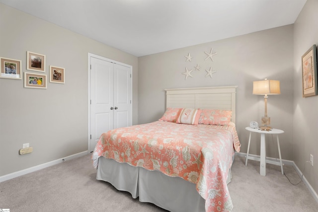 bedroom with carpet, baseboards, and a closet