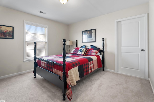 carpeted bedroom featuring visible vents and baseboards