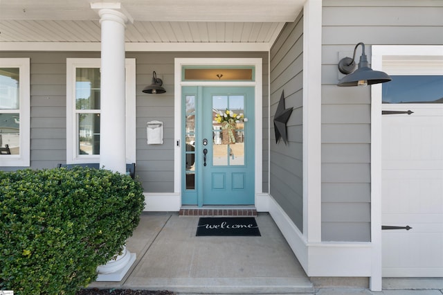 view of exterior entry featuring covered porch