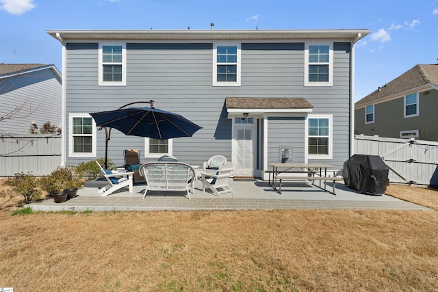 back of house with a patio area, a yard, and fence