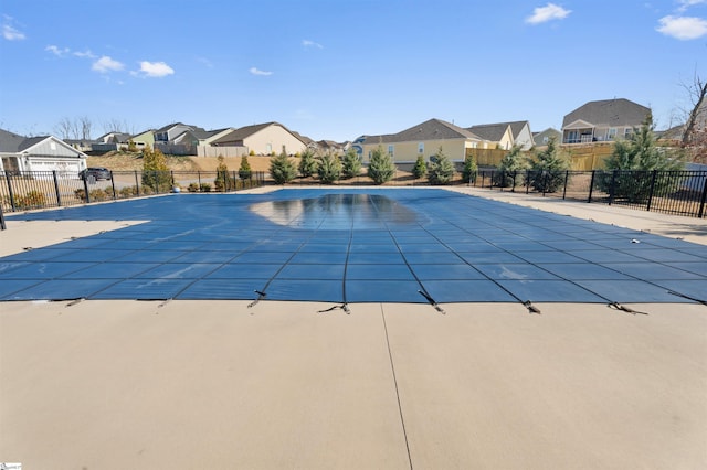 view of swimming pool with a residential view, a fenced in pool, a patio, and fence