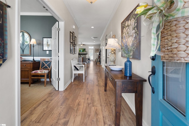 entryway featuring crown molding, recessed lighting, wood finished floors, and baseboards