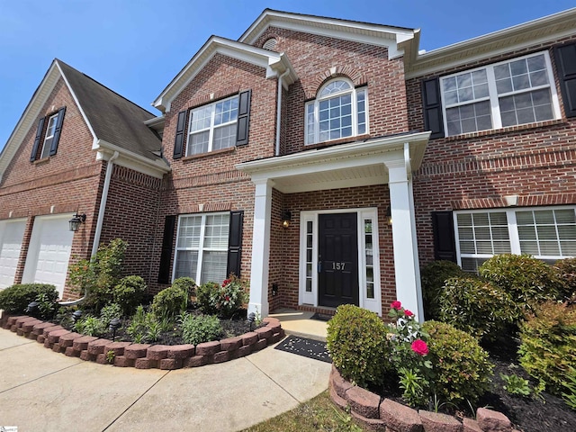 traditional home with an attached garage and brick siding