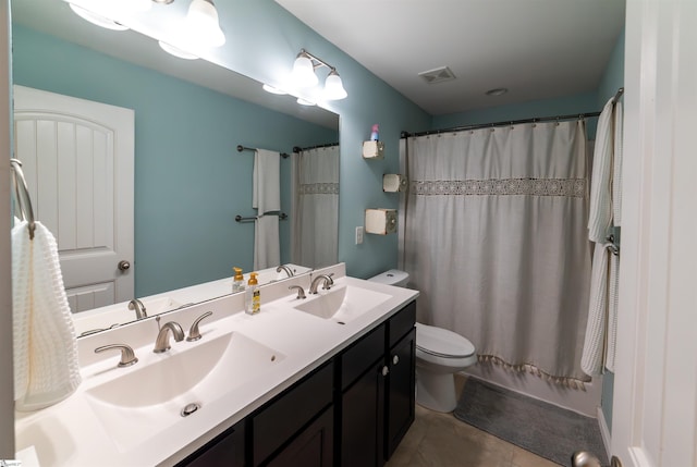 full bath featuring double vanity, toilet, visible vents, and a sink