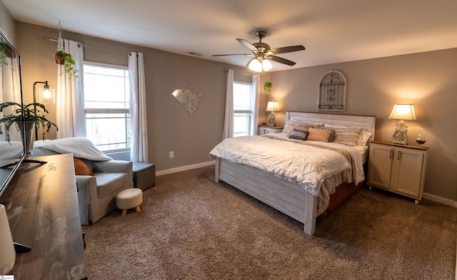 bedroom featuring multiple windows, baseboards, and dark colored carpet