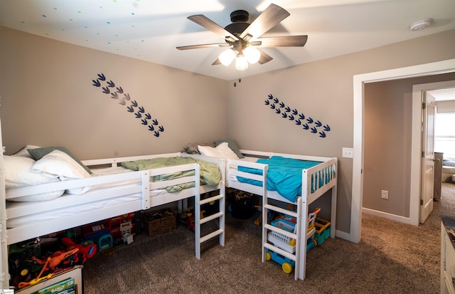 carpeted bedroom featuring baseboards and ceiling fan