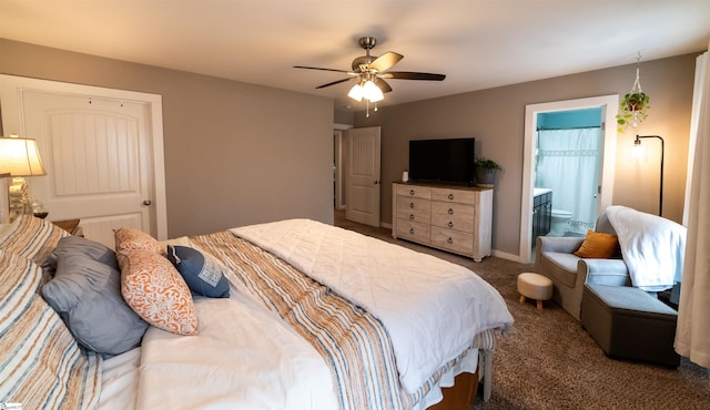 carpeted bedroom featuring baseboards, ensuite bath, and a ceiling fan